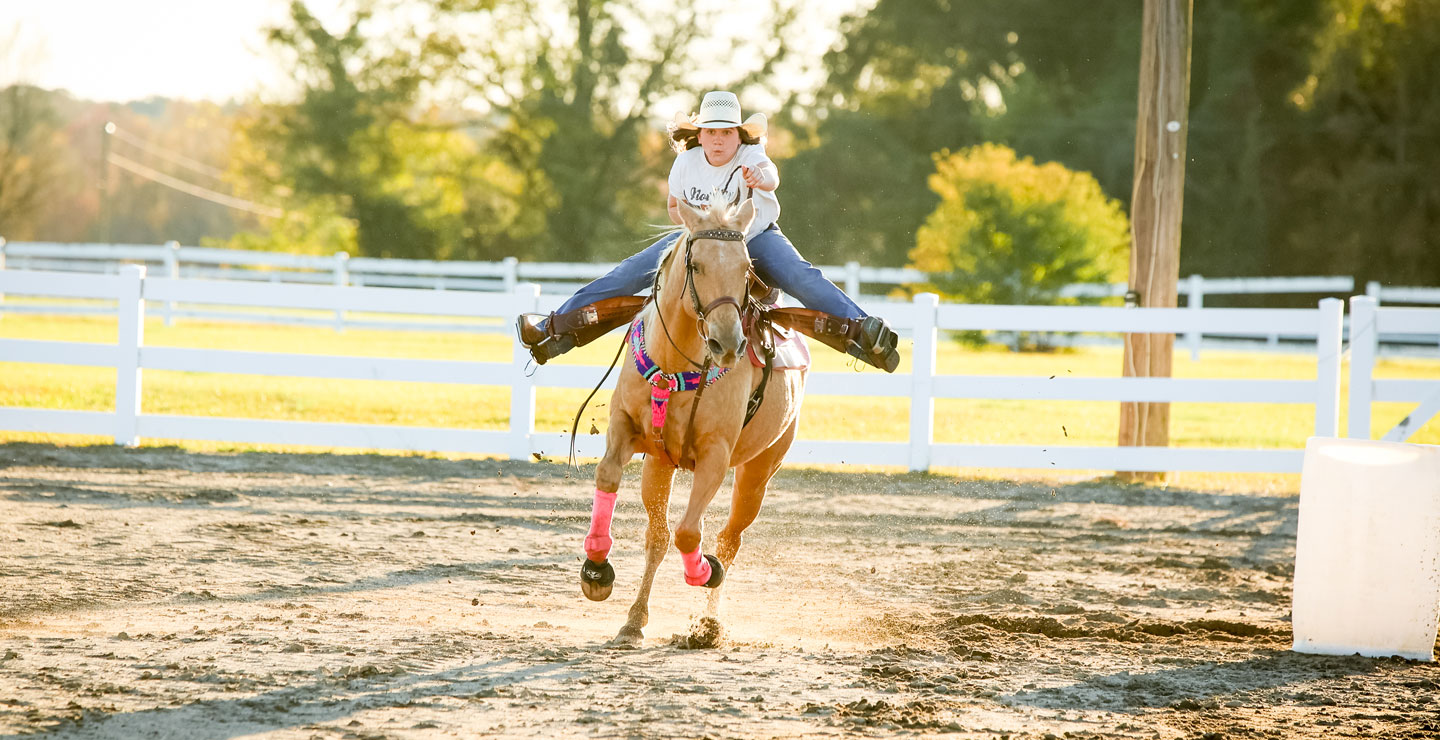 Ella Nipper riding her palomino horse, running fast.